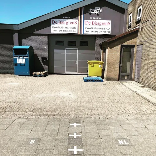 Auto shop in counter-exclave N2 where the international border cuts through the property.