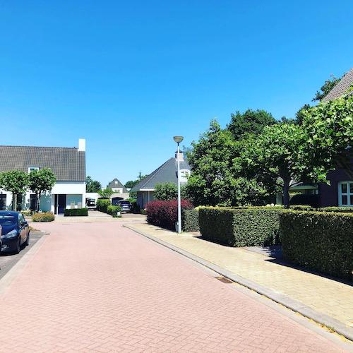 Street scene in counter-exclave N3 with vehicles showing different country codes on license plates.